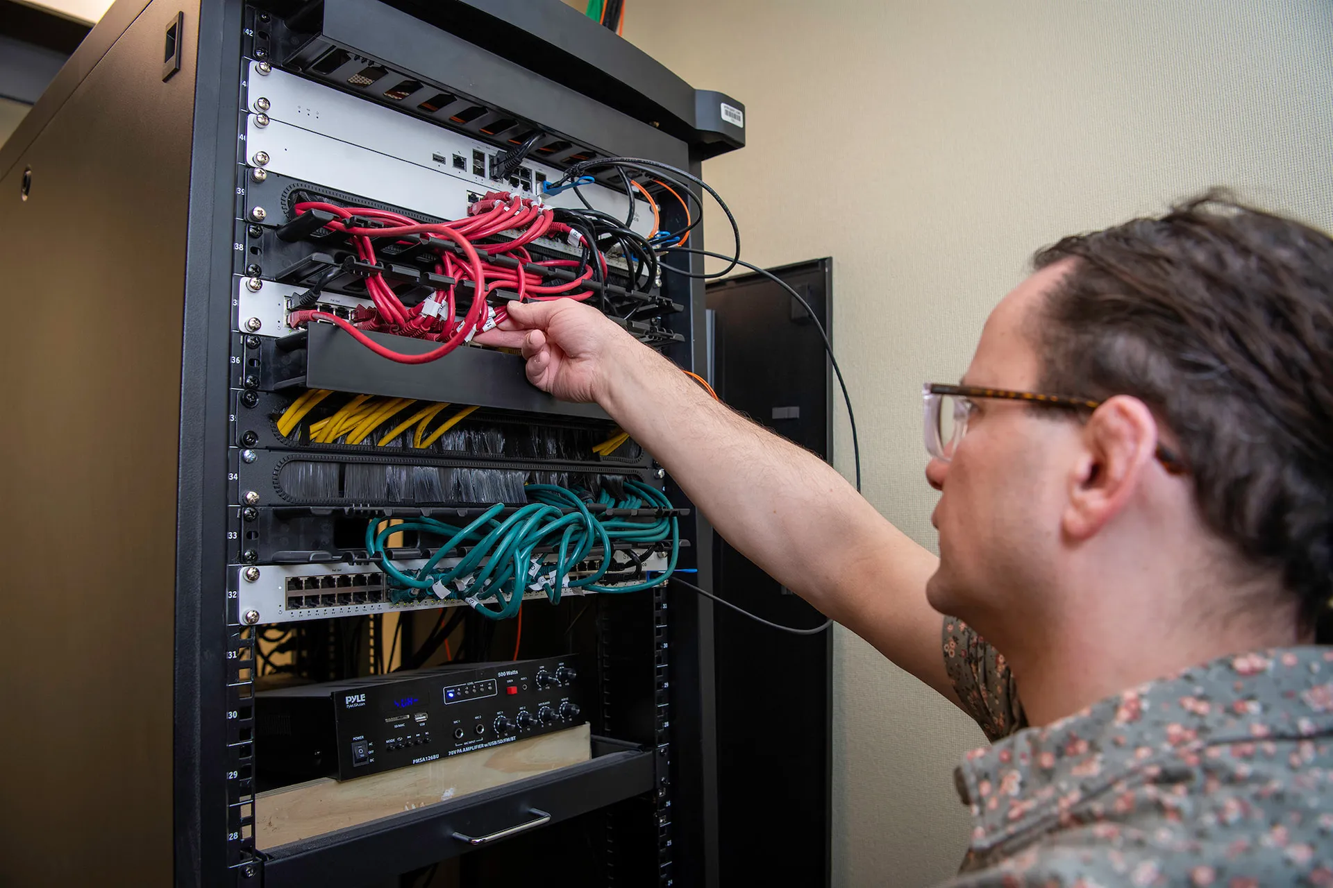 Technician working on a server rack